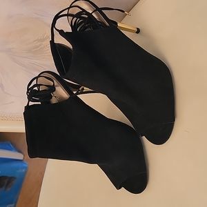 High heeled suede open toe shoes with strings that tie up your leg or ankle.